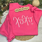 Pink sweatshirt with 'XOXO' design .