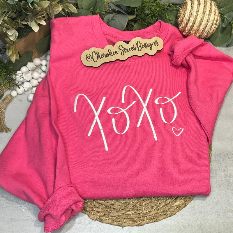 Pink sweatshirt with 'XOXO' design .