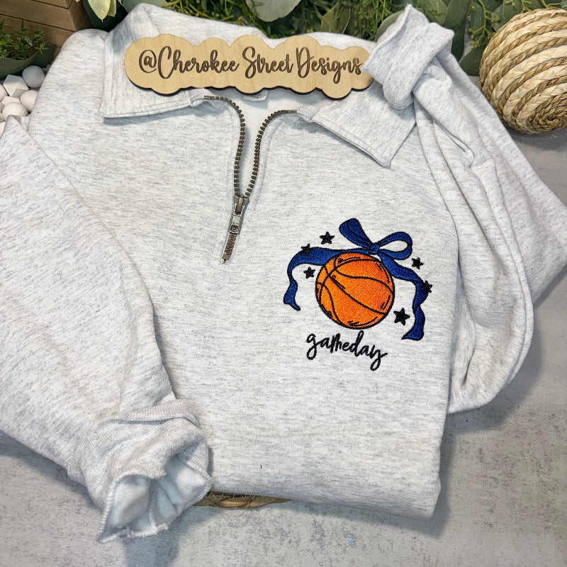 Gray hoodie with basketball and bow design on a light gray background