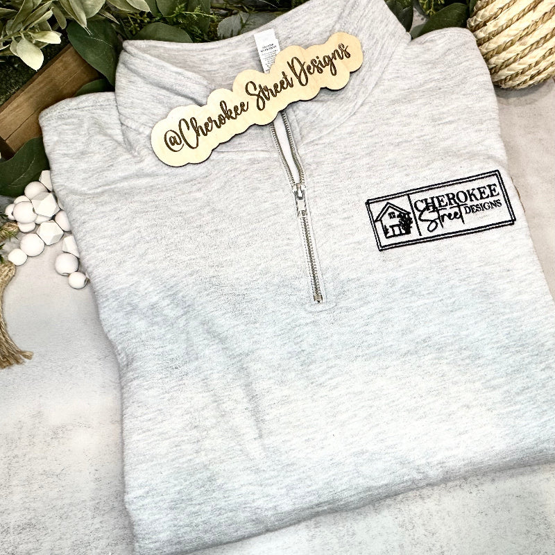 Gray zip-up hoodie with Cherokee Street Designs logo