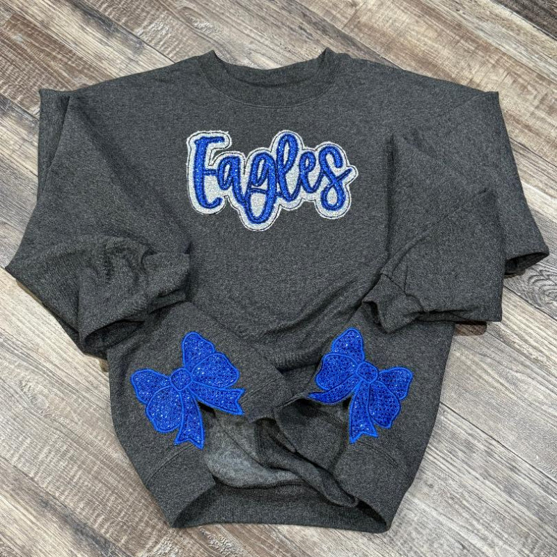 Gray sweatshirt with 'Eagles' text and blue bows 
