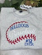 A folded heather gray sweatshirt with a baseball graphic reading 'BULLDOGS Baseball #12 DYER' in blue and white, with red baseball-stitch-style outlines. A small tag at the collar reads Cherokee S.