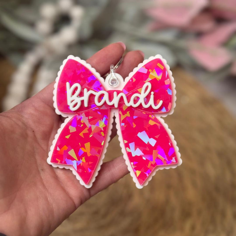 Pink bow-shaped keychain with 