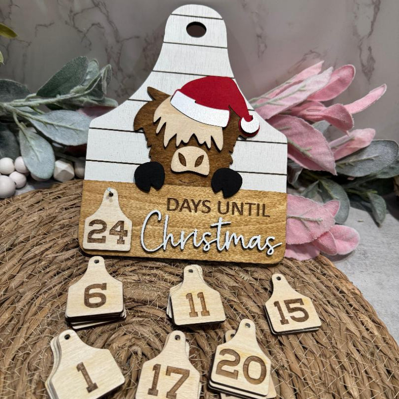 Wooden Christmas countdown ornament with cow design and numbered tags 