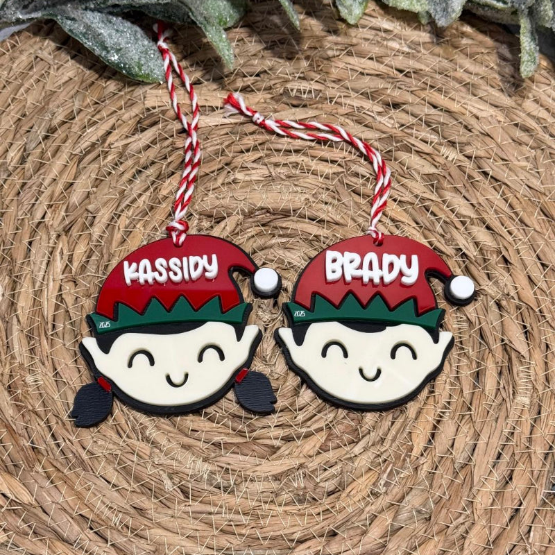 Two Christmas-themed elf ornaments with names 'Kassidy' and 'Brady' 
