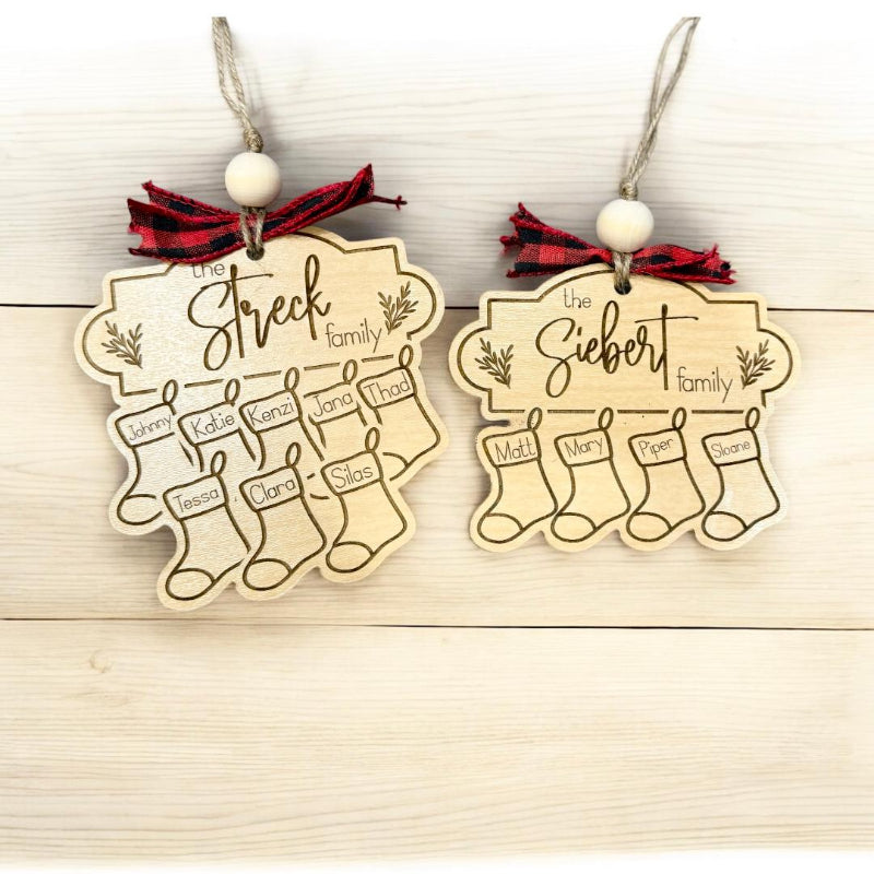 Two wooden Christmas ornaments with family names and stockings
