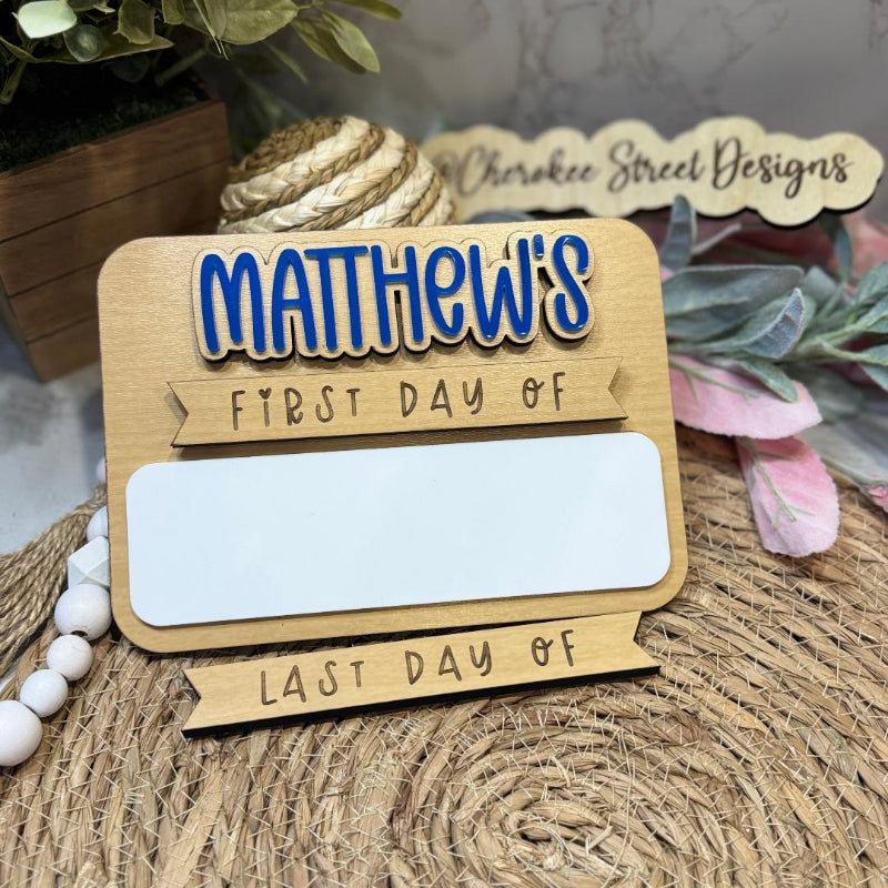 Wooden sign with  First Day of' and 'Last Day of' text 