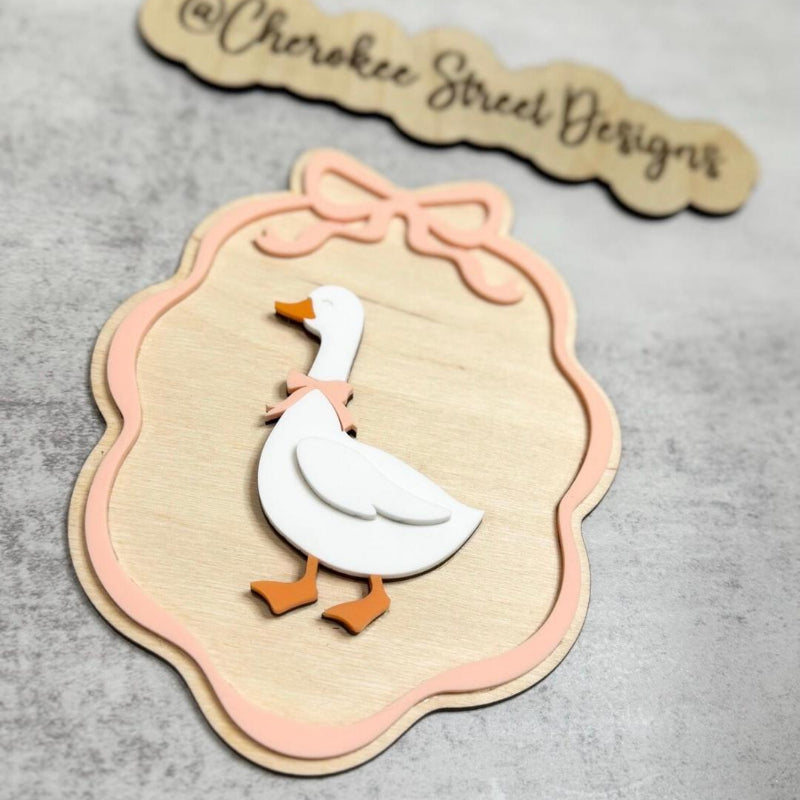 Decorative paper cutout of a goose with a decorative frame 