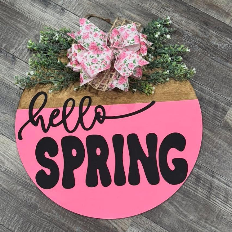 Decorative sign with 'hello SPRING' text and floral bow 