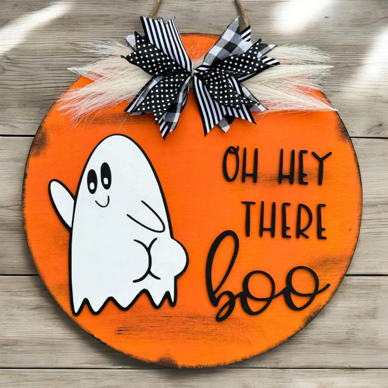 Halloween-themed wooden sign with a ghost and 'OH HEY THERE boo' text on an orange background.