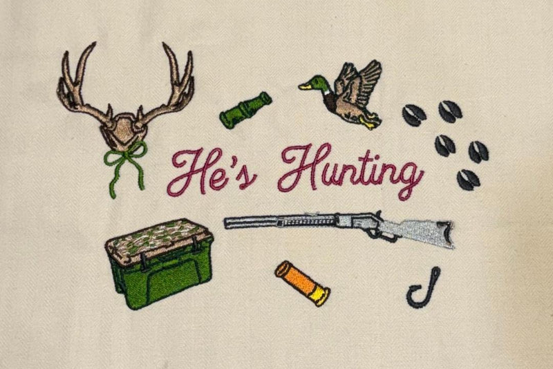 Embroidered design with hunting-themed elements on a beige background