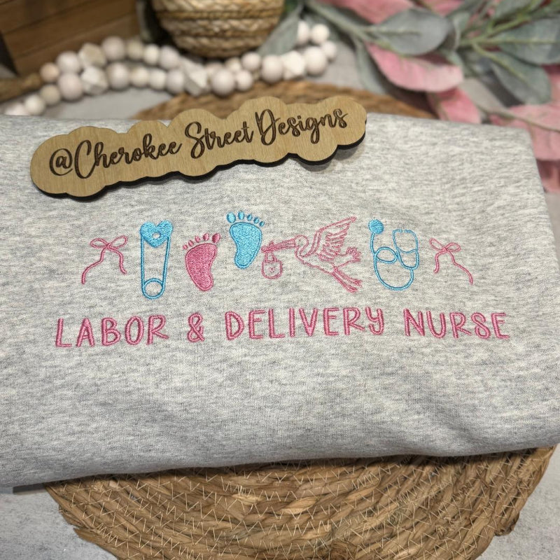 Gray sweatshirt with 'Labor & Delivery Nurse' design .