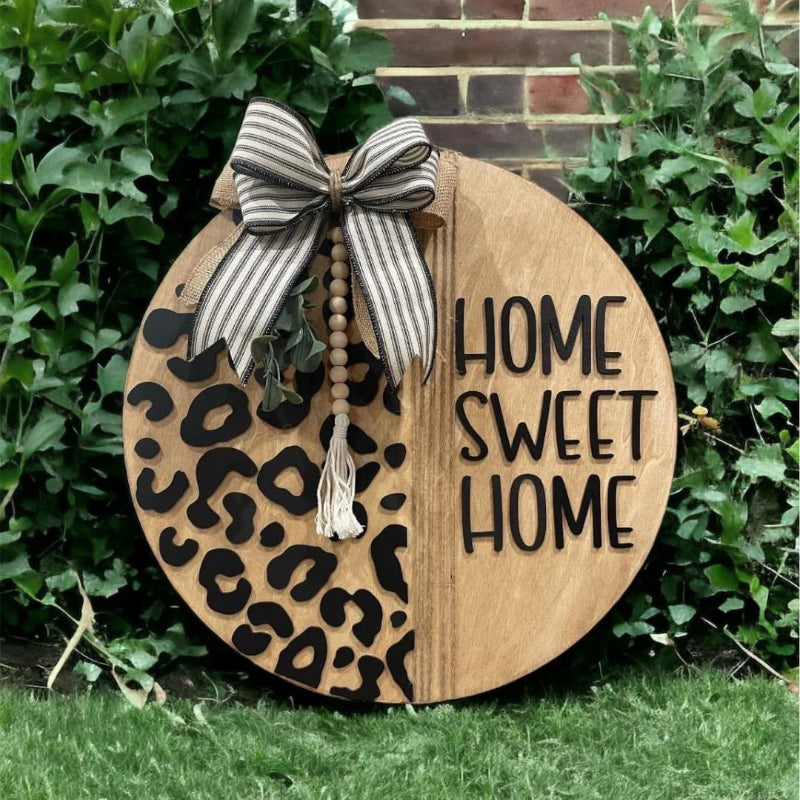 Decorative sign with 'Home Sweet Home' text and leopard print design, 