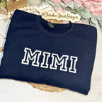 Navy sweatshirt with 'MIMI' printed on it
