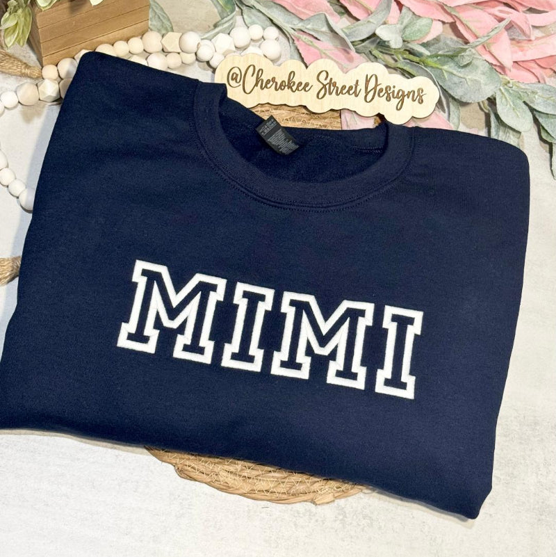 Navy sweatshirt with 'MIMI' printed on it