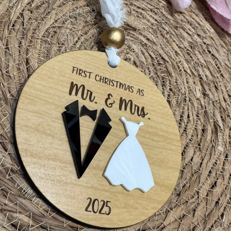 Wooden ornament with 'First Christmas as Mr. & Mrs.' and year 2025 