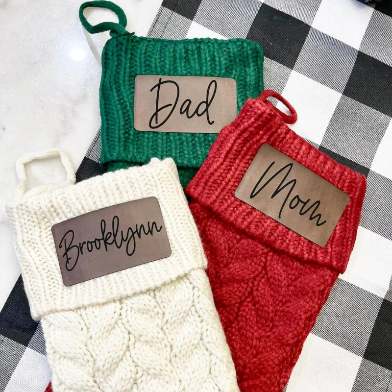 Three knitted stockings with name tags 