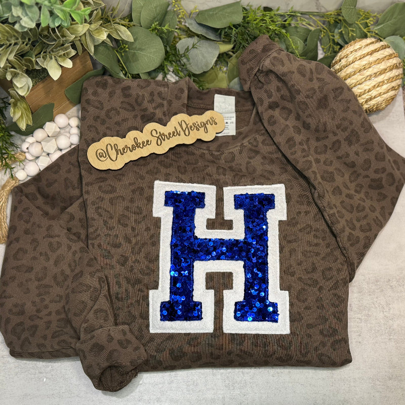 Brown leopard print sweatshirt with blue sequin 'H' 