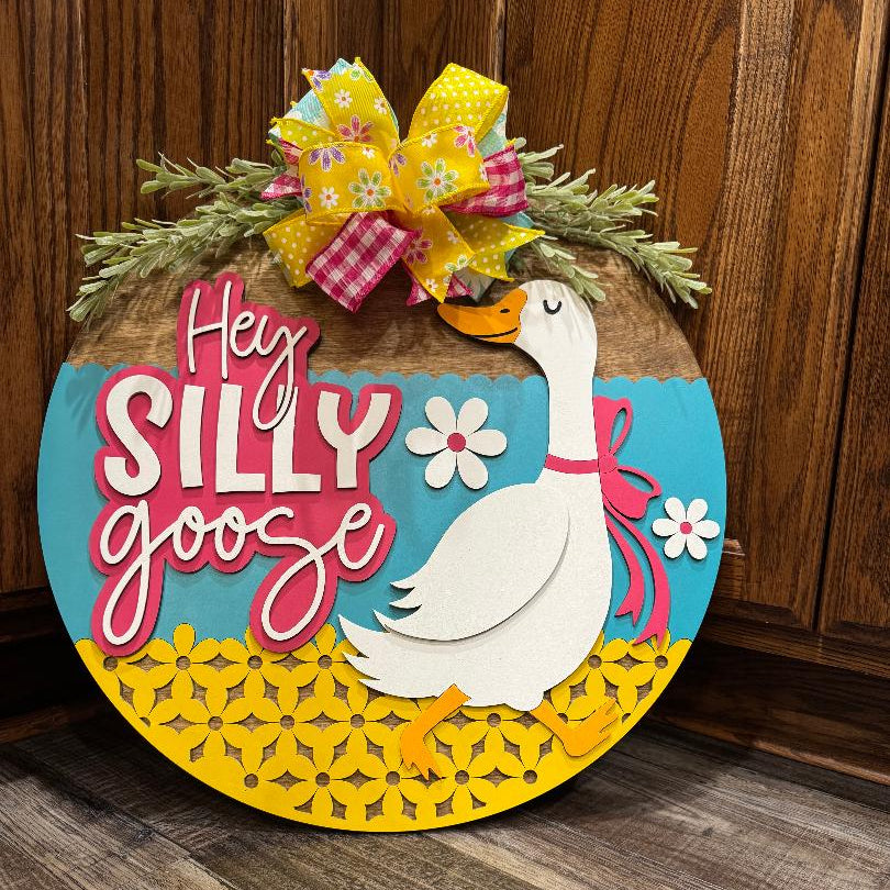 Decorative sign with a goose illustration and 'Hey Silly Goose' text 