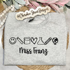 Gray sweatshirt with icons and text 'Miss Franz' 