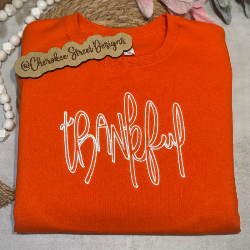  orange sweatshirt with 'thankful' text 