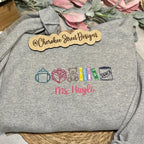 Gray sweatshirt with embroidered designs and text